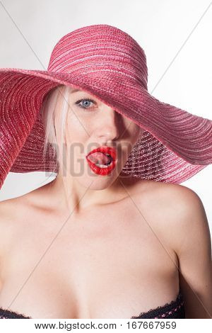 woman with a hat tonque red lips
