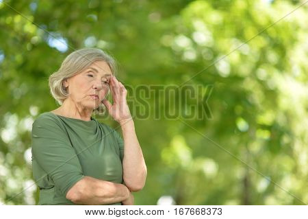 Portrait of a mature woman, upset posing outdoors