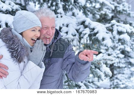 happy father with daughter, smiling and posing outdoors in winter