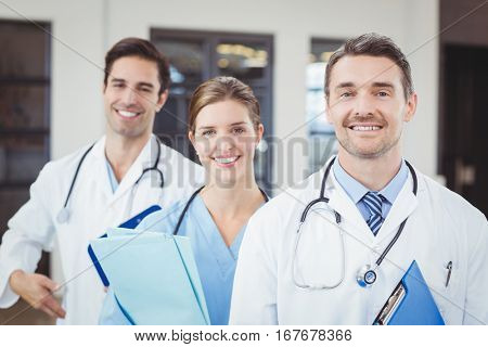 Portrait of cheerful docors standing in row at hospital