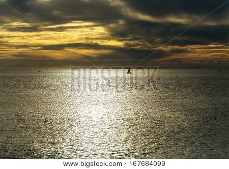 Dramatic Evening Seascape With Sailing Boat On Dark Sea