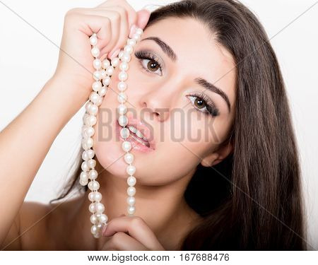 fashion sexy young woman in lacy lingerie with pearls jewellery.