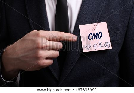 Business, Technology, Internet And Network Concept. Young Businessman Shows The Word: Cmo