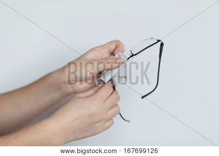 Women Hand Cleaning Glasses Lens With Isolated Background.