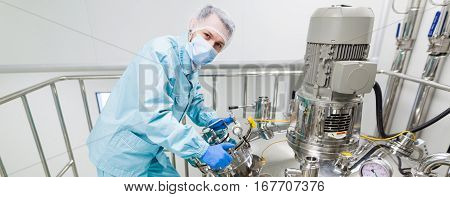 look at camera scientist is working with high-pressure tank