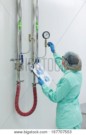 worker on factory checking pressure in chemical factory