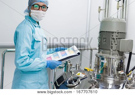 scientist is checking high-pressure tank in pharmaciutical factory