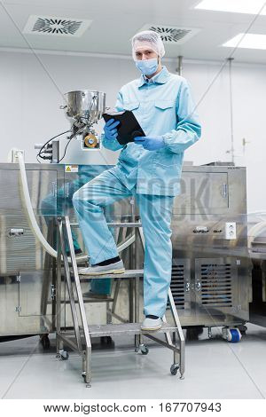 Plant Picture, Factory Worker Making Notes About Machine, Stand On Ladder