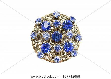 Golden medallion with sapphires and topazes isolated over white