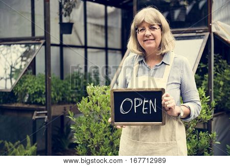 Mature Open Sign Garden Shop