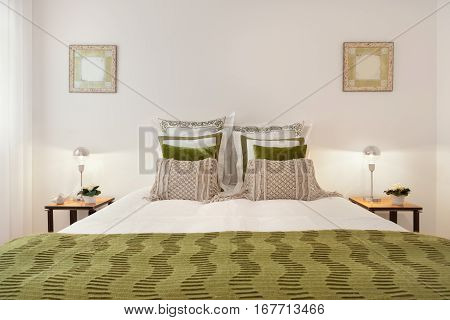 Luxury Bedroom Suite With Green Blanket and Pillows