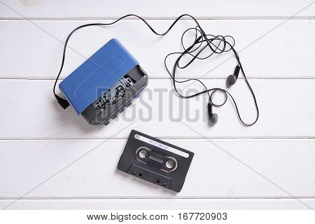 vintage cassette player with earbuds and mix tape