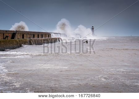 Crashing Waves on Tynemouth North Pier, as a stormy sea hits, resulting in high crashing waves cascading into the mouth of the River Tyne