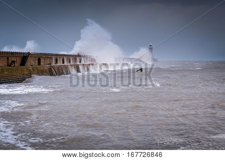 Tynemouth Storm Waves, as a stormy sea hits Tynemouth North Pier, resulting in high crashing waves cascading into the mouth of the River Tyne