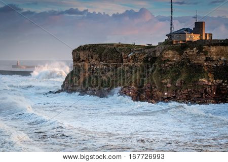 Tynemouth Coast Guard Station and Stormy Sea, as it hits Tynemouth North Pier resulting in high crashing waves cascading into the mouth of the River Tyne