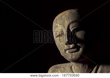 Buddhist monk carving in the form of an aged relic Face showing serene contentment.