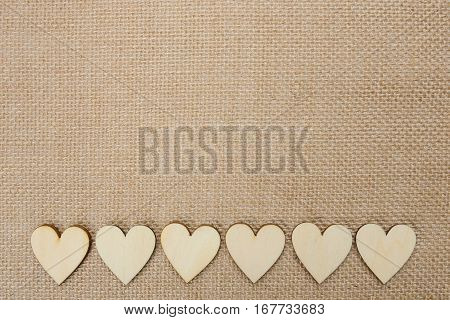 Wood hearts on hessian texture background valentine background