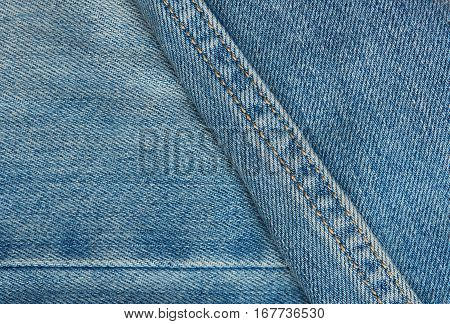 light blue jeans surface with stiches close up
