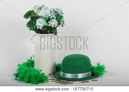 St. Patrick's Day hat with vase of flowers and coins.