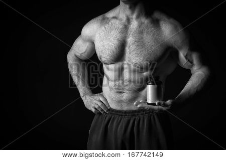 Handsome Sexy Athlete Man With Muscular Body Holds Steroid Jar