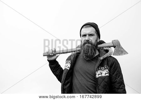 Bearded Handsome Serious Man With Rusty Axe Against Cloudy Sky