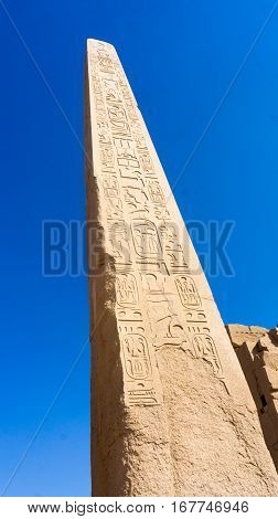 Ruins of an ancient temple of Egypt with statues and columns