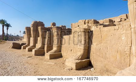 Ruins of an ancient temple of Egypt with statues and columns