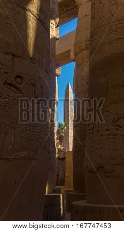 Ruins of an ancient temple of Egypt with statues and columns
