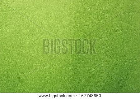 Lime green leather texture closeup background. Structured background design nubuk