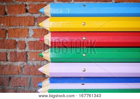Street bench made from big multicolor pencils, close-up view