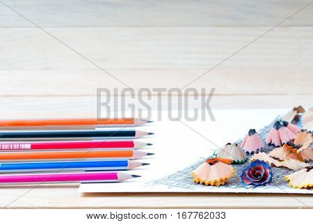 Pencil sharpener shavings on the white paper. Back to school. Copy space.