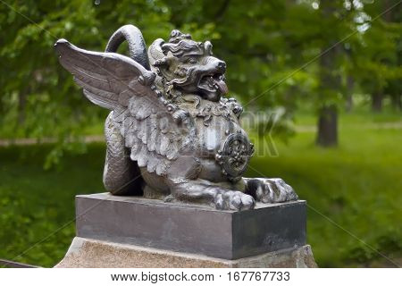 cast-iron figure of a winged dragon on the Dragon Bridge in park Pushkin