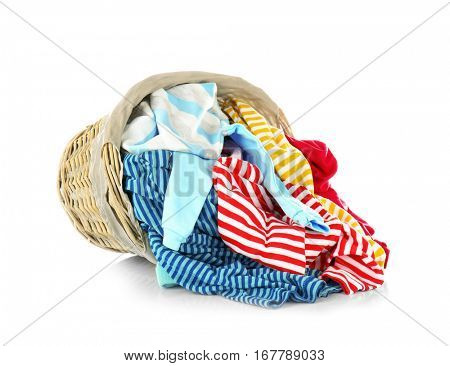 Clothes in wicker basket on white background