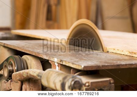 Carpenter tools on wooden table with sawdust. Circular Saw. Carpenter workplace top view.