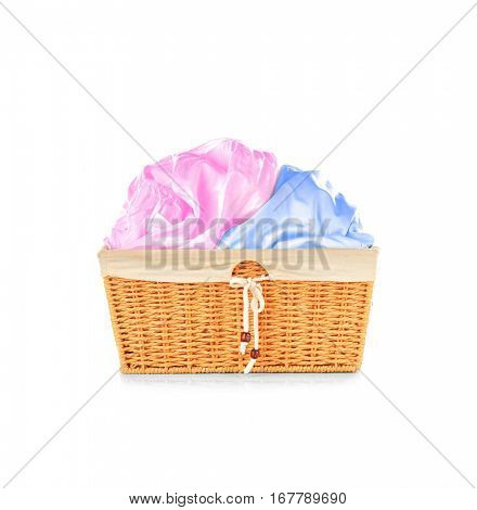 Clothes in wicker basket on white background