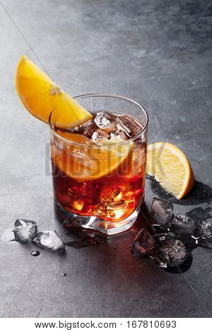 Negroni cocktail on dark stone table 