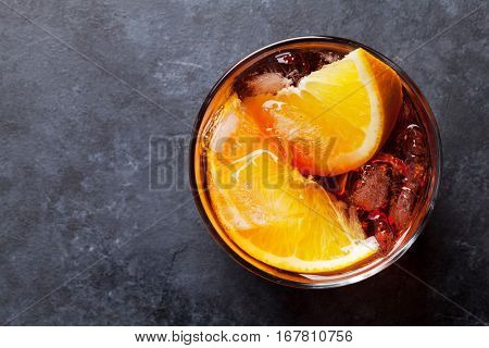Negroni cocktail on dark stone table. Top view with space for your text 