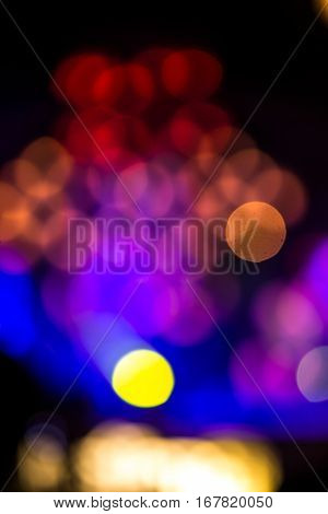 Abstract background with defocused bokeh of laser show in modern disco party night club - Concept of nightlife with music and entertainment - Image with powered colored halos and vivid bright lights