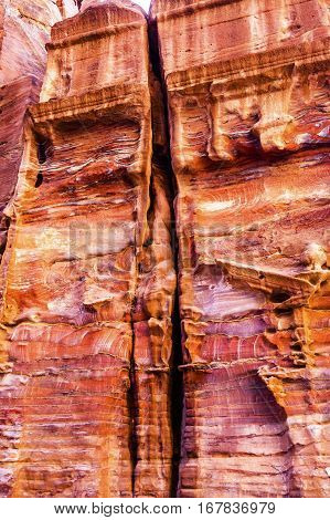 Rose Red Rock Tomb Street of Facades Petra Jordan. Built by the Nabataens in 200 BC to 400 AD. Rose Red canyon walls create many abstracts close up. Inside the Tombs the rose red can become blood red. Reds are created by magnesium in sandstone.