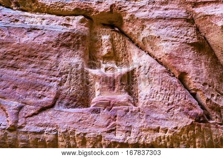 Entrance Symbol Outer Siq Canyon Petra Jordan. Colorful Yellow Pink Canyon becomes rose red when sun goes. The rose red can become blood red. Reds are created by magnesium in sandstone.
