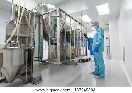 Scientist Stand Near Chromed Barrels