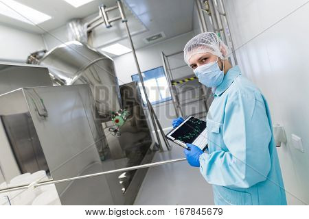 Scientist Make Notes About Metal Machine With Barrels