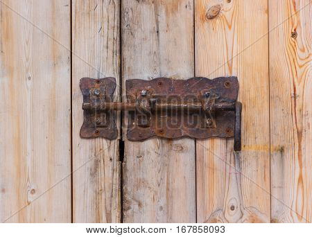 Old rusty lock on a wooden door. Rusty heck