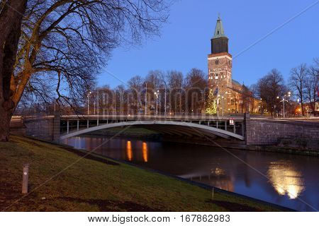 TURKU, FINLAND - DECEMBER 25, 2016: View to the Turku Cathedral and the river Aura. It is the central church of the Archdiocese of Turku and the seat of the Archbishop of Finland