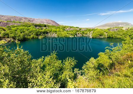Looking across the disused Dorothea Slate Quarry Nantlle Gwynedd Wales United Kingdom. Flooded with water.