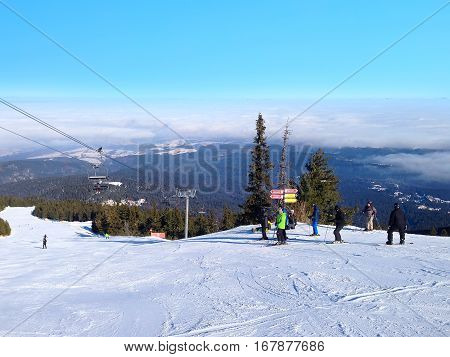 Borovets, Bulgaria - January 30, 2017: Panorama of winter mountains, skiers on ski slopes in bulgarian alpine ski resort Borovets