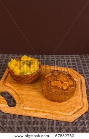 Game Pie Served With Bowl Of Piccalilli