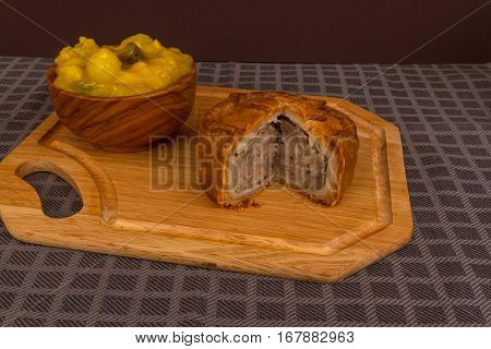 Game Pie Served With Bowl Of Piccalilli