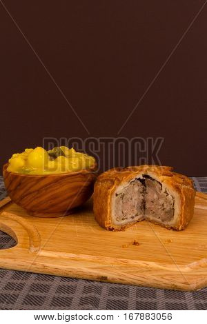 Game Pie Served With Bowl Of Piccalilli