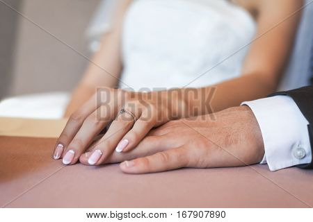 Happy wedding couple holding hands together as forever love. Wedd ring